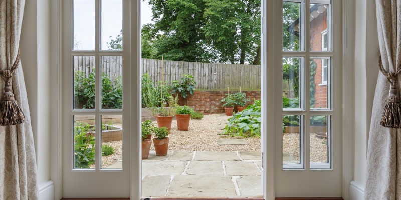 French doors that leads to patio with pavers