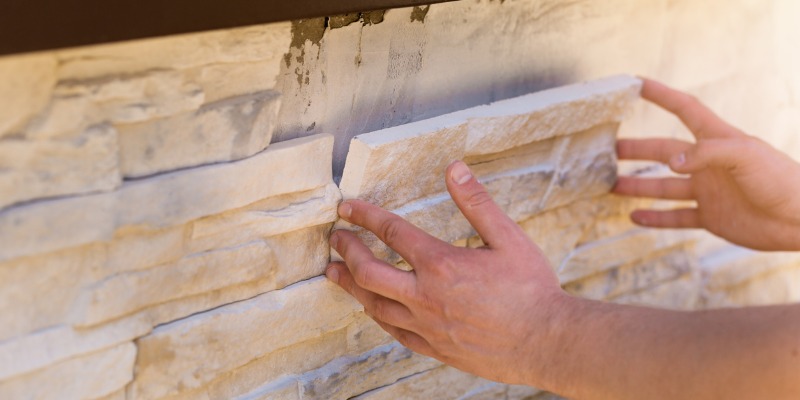 Man installing brick veneer