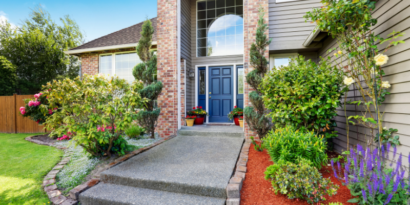 Exterior of home with brick veneer entrance and accent wall - Your Complete Guide to Installing Brick Veneer